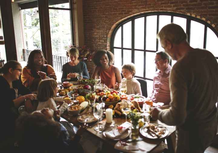 A family is gathered around a table for a holiday dinner.