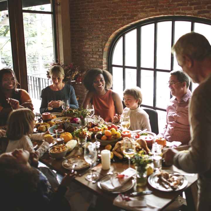 A family is gathered around a table for a holiday dinner.