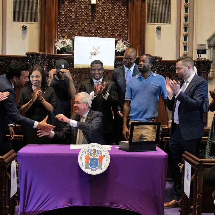 ACLU-NJ Executive Director shakes hands with New Jersey Governor Phil Murphy at the Clemency Executive Order Announcement.