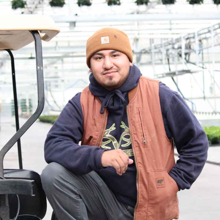 man standing in greenhouse