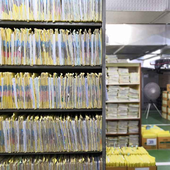 A room with files packed on bookshelves in a room