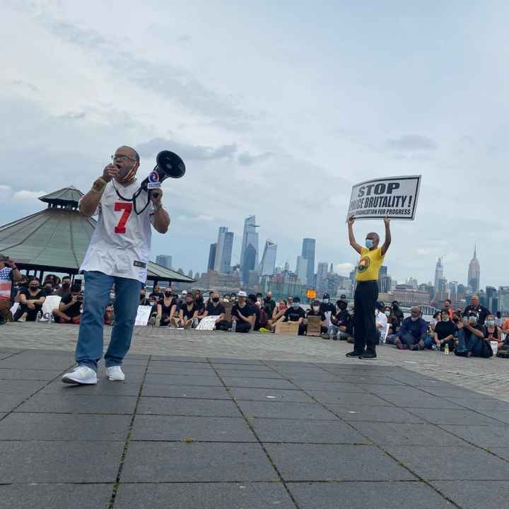 Zayid Muhammad holds a megaphone at a People's Organization for Progress rally